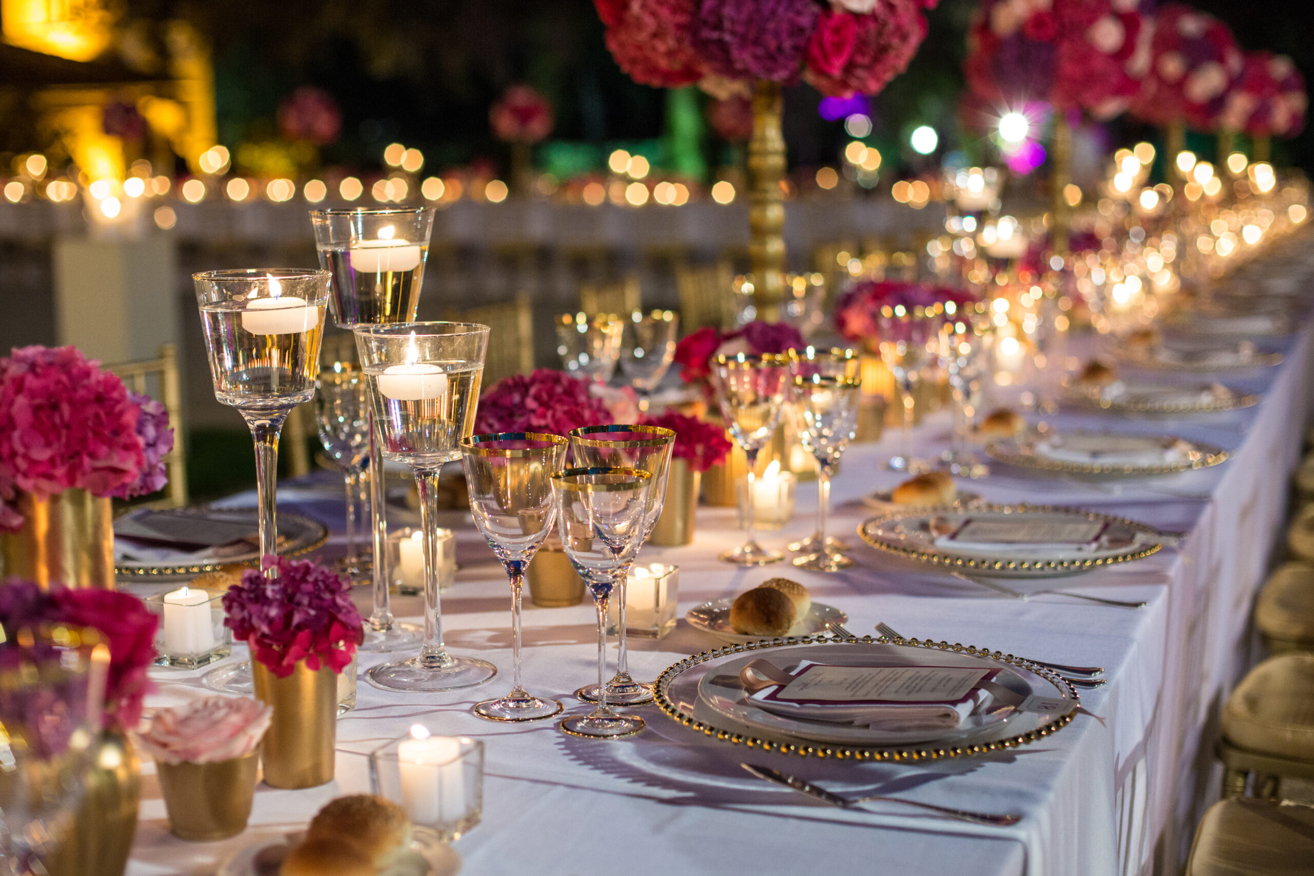 Elegant,Table,Set,With,Glasses,Decorated,In,Gold,,Lighted,Candles